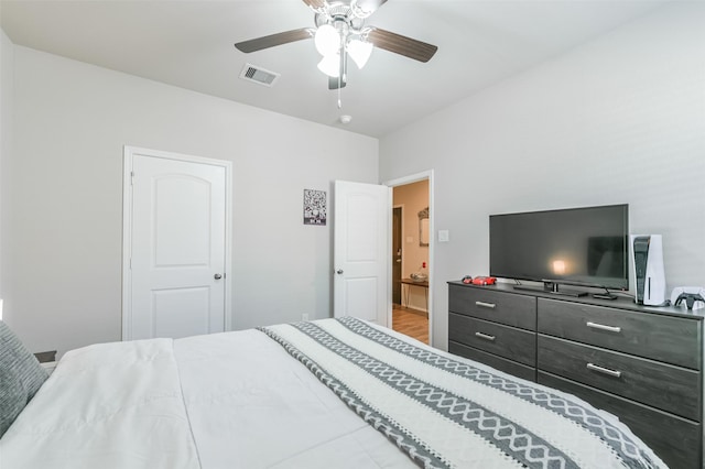 bedroom with hardwood / wood-style floors and ceiling fan