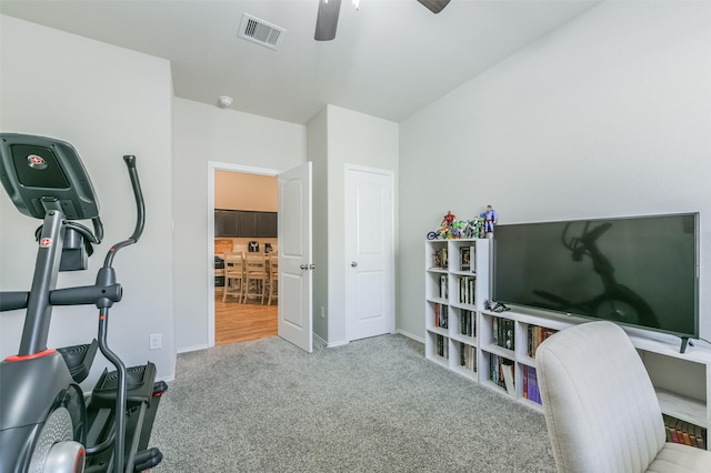 interior space with light carpet and ceiling fan