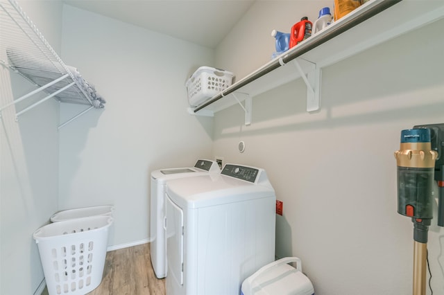 clothes washing area featuring light hardwood / wood-style flooring and independent washer and dryer