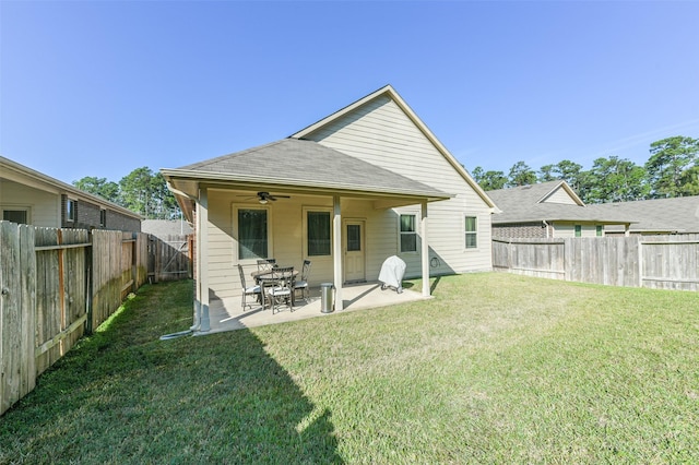 back of house with a lawn, ceiling fan, and a patio area