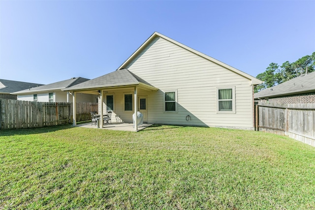 rear view of house with a patio area and a yard