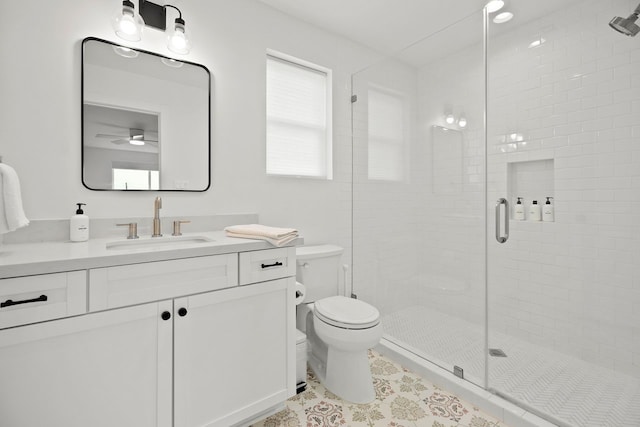 bathroom featuring tile patterned floors, vanity, toilet, and an enclosed shower