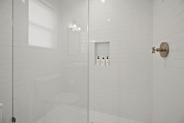 bathroom with a shower with door