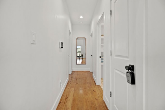 corridor with light wood-type flooring