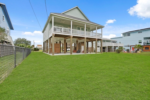 rear view of house with a yard and a patio