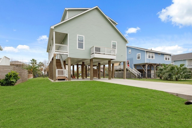 back of property featuring a lawn, a balcony, and a carport