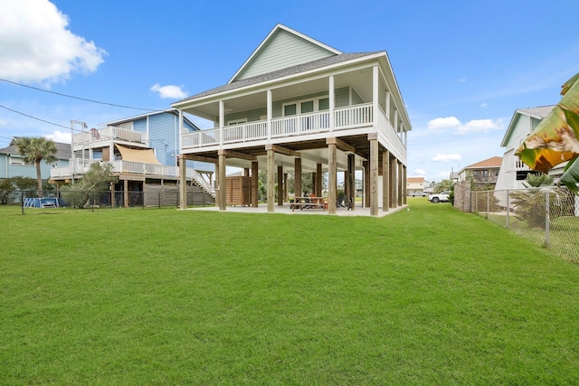 back of property with a patio area and a lawn