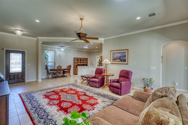 tiled living room featuring ceiling fan and ornamental molding