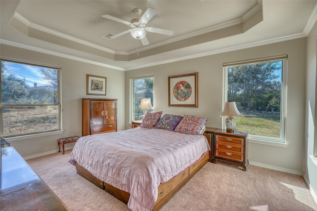 bedroom with ceiling fan, crown molding, and a tray ceiling