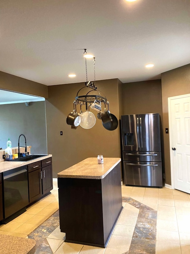 kitchen featuring a sink, light tile patterned floors, stainless steel refrigerator with ice dispenser, and dishwasher