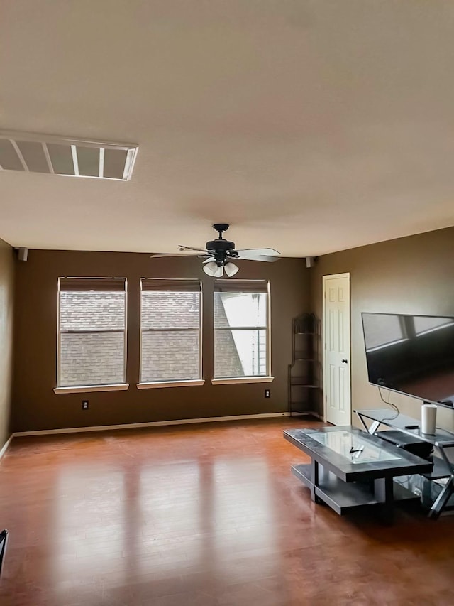 living room with ceiling fan, wood finished floors, and baseboards