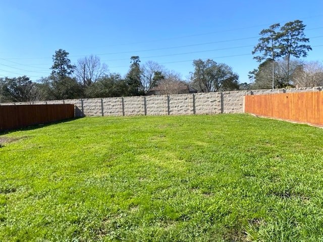 view of yard with a fenced backyard