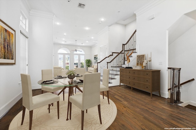 dining area featuring ceiling fan, ornamental molding, and dark wood-type flooring