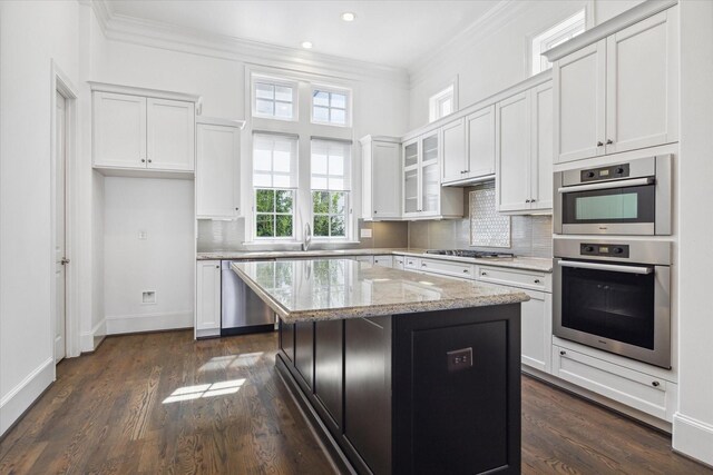 kitchen featuring a center island, white cabinetry, and appliances with stainless steel finishes