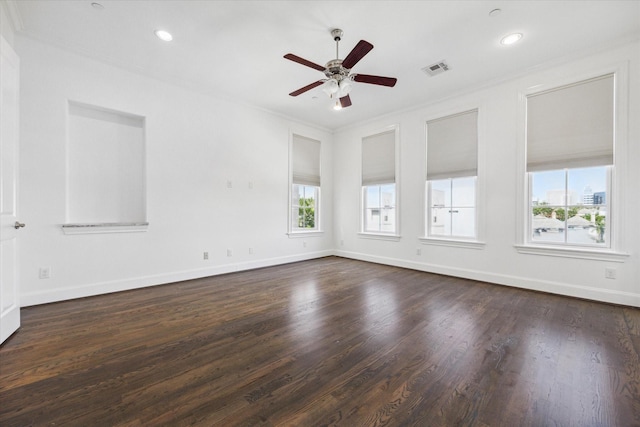 empty room with dark hardwood / wood-style floors, ceiling fan, and ornamental molding