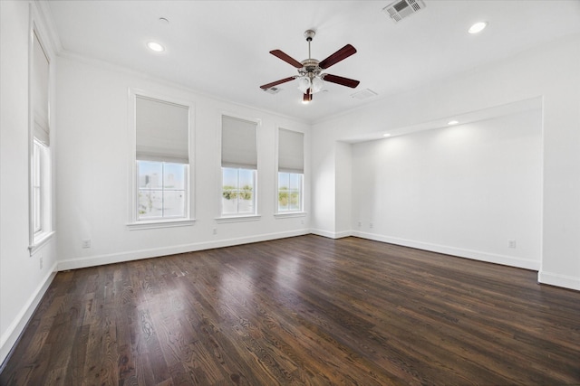 empty room with crown molding, ceiling fan, and dark wood-type flooring