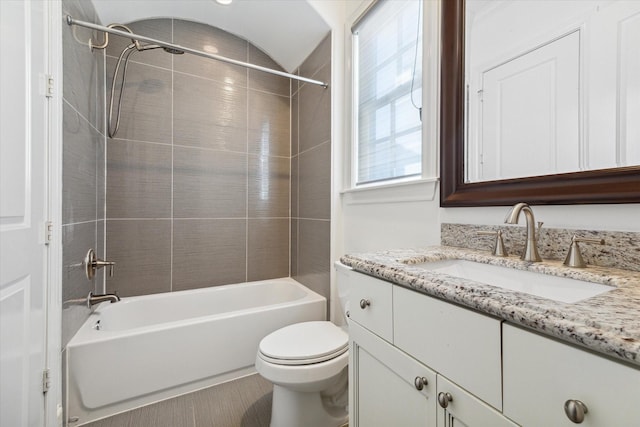 full bathroom featuring tile patterned floors, toilet, vanity, and tiled shower / bath