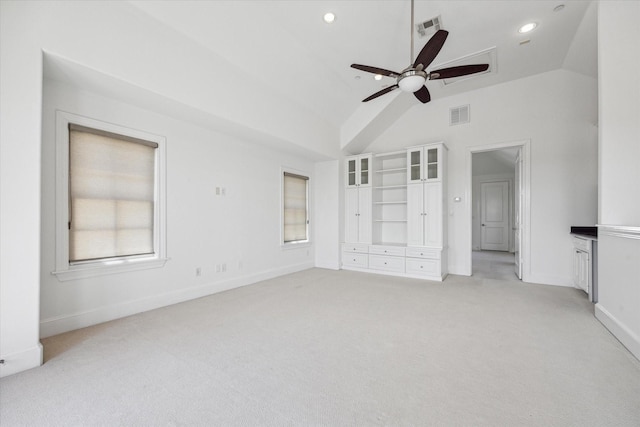 unfurnished bedroom featuring ceiling fan, light colored carpet, and lofted ceiling