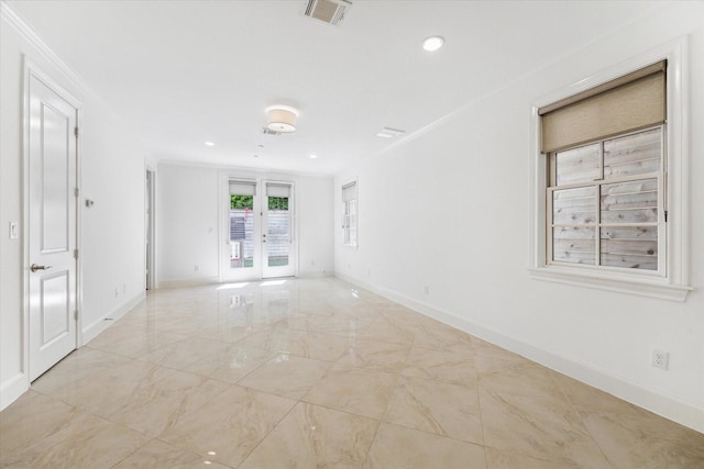 unfurnished room featuring ornamental molding and french doors