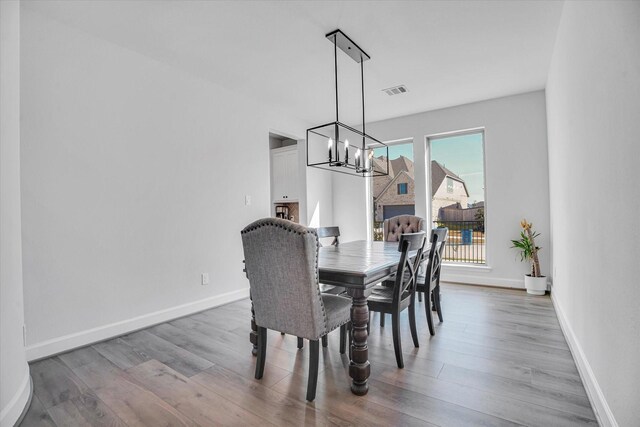 dining space featuring a chandelier and hardwood / wood-style floors