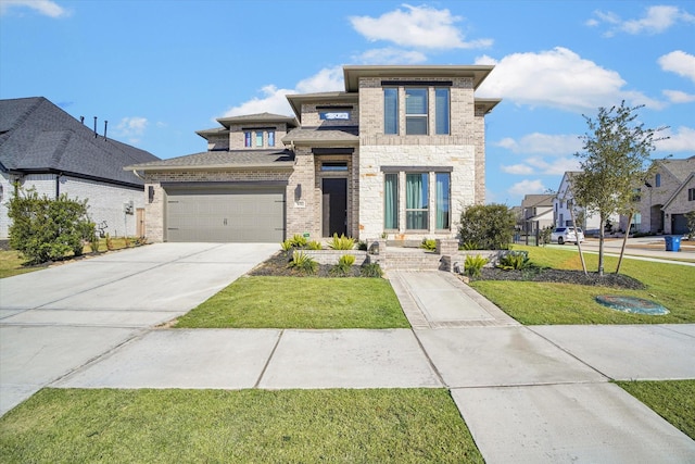 prairie-style house with a front yard and a garage