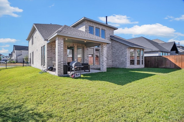 rear view of house featuring a lawn and a patio area