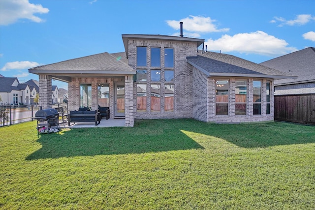 rear view of house with a patio area and a lawn