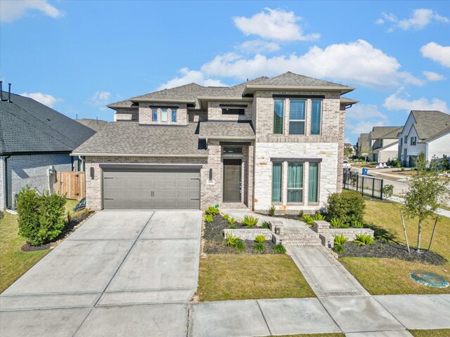 view of front of house with a front yard and a garage