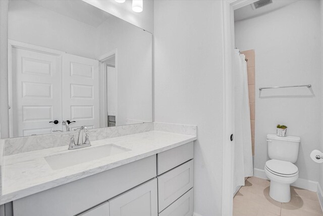 bathroom with vanity, a shower with curtain, tile patterned floors, and toilet