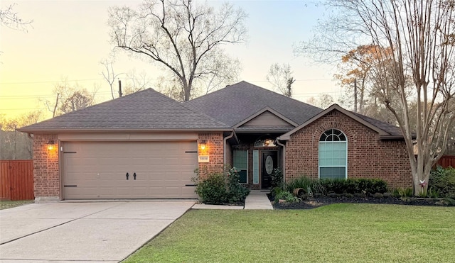 ranch-style house with a lawn and a garage