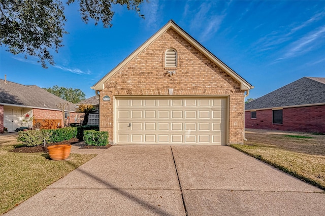 view of front of property featuring a garage, brick siding, and a front lawn