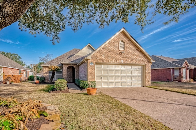 view of front of home featuring a garage, a front lawn, concrete driveway, and brick siding