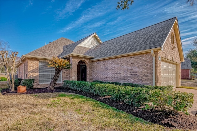 single story home with brick siding, roof with shingles, a front yard, a garage, and driveway