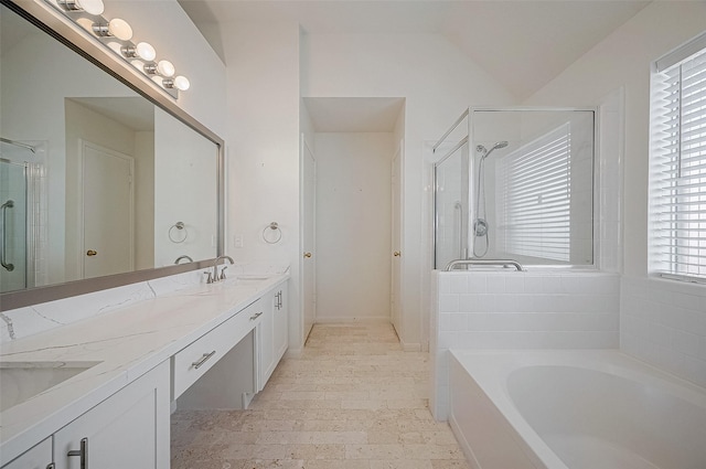 full bathroom featuring double vanity, a stall shower, a sink, and a bath