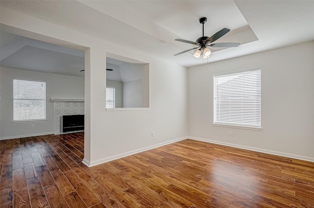 unfurnished room featuring hardwood / wood-style floors, a healthy amount of sunlight, and baseboards