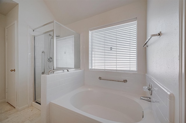 full bathroom featuring a stall shower and a bath