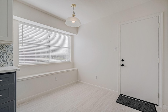 dining area with light wood-style floors and baseboards