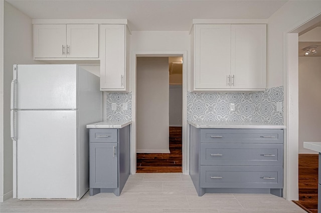 kitchen with freestanding refrigerator, light countertops, gray cabinetry, and white cabinetry