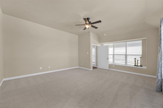 unfurnished room featuring lofted ceiling, light carpet, ceiling fan, and baseboards