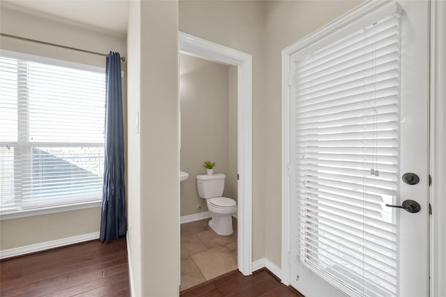 bathroom with wood-type flooring and toilet