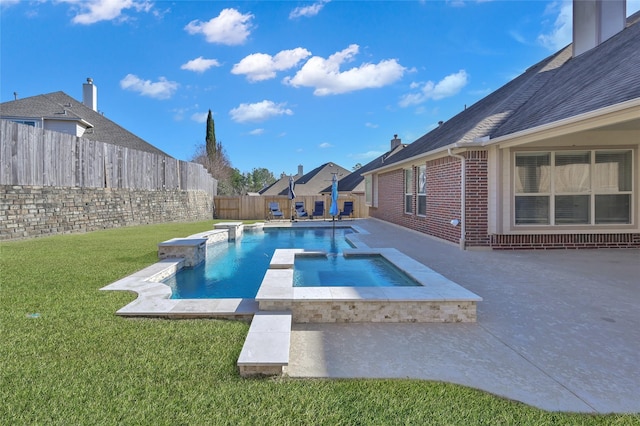 view of swimming pool with an in ground hot tub, a patio area, and a lawn