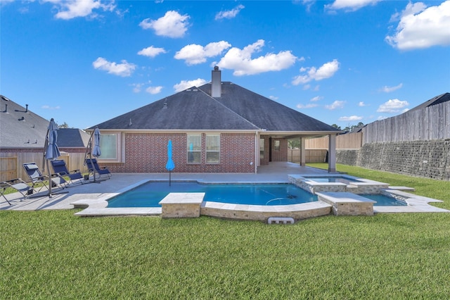 view of swimming pool featuring an in ground hot tub, a yard, and a patio area