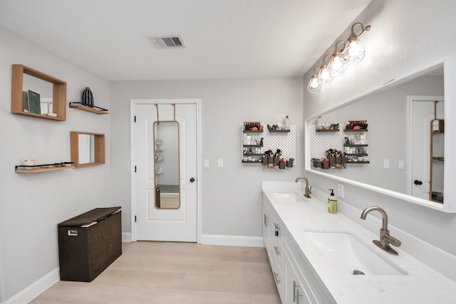 bathroom with hardwood / wood-style floors and vanity