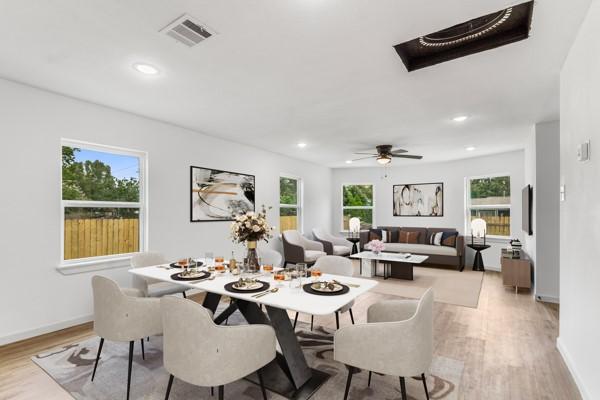 dining room featuring ceiling fan, light hardwood / wood-style floors, and a wealth of natural light