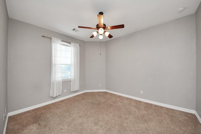 empty room featuring carpet floors and ceiling fan