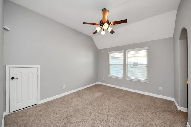 carpeted empty room featuring ceiling fan and vaulted ceiling