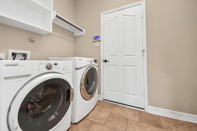 washroom with washer and clothes dryer and light tile patterned flooring