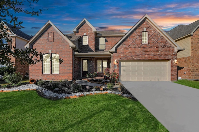 view of property with a garage and a yard