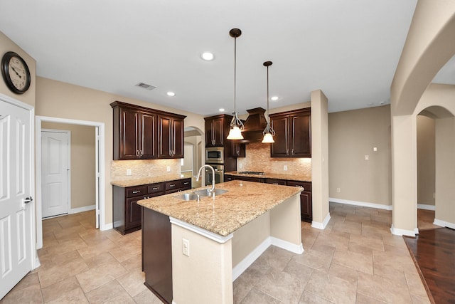 kitchen featuring sink, an island with sink, decorative light fixtures, island range hood, and stainless steel appliances