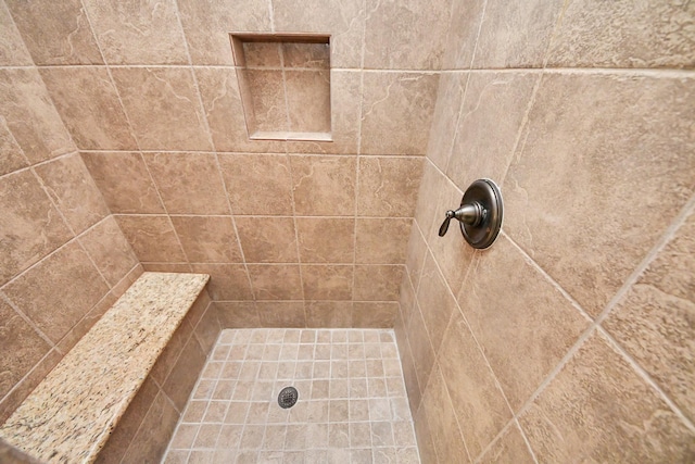 bathroom with tiled shower